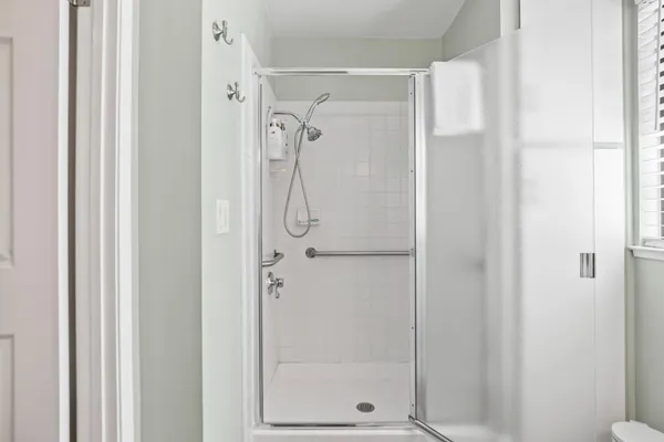 a bathroom with a glass shower door