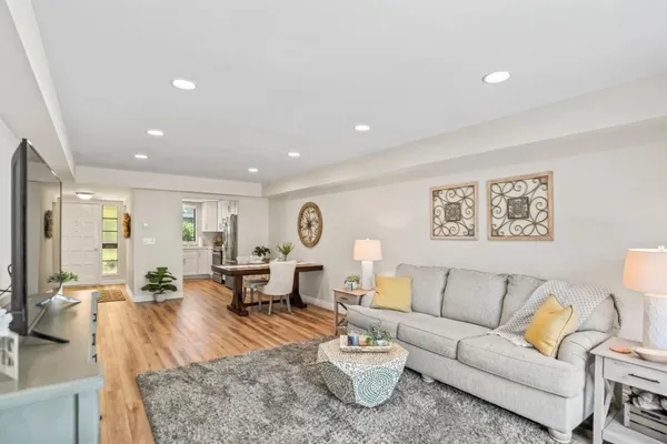 a living room with furniture and wooden floor