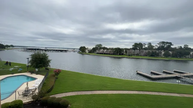 a view of a lake with houses in the back
