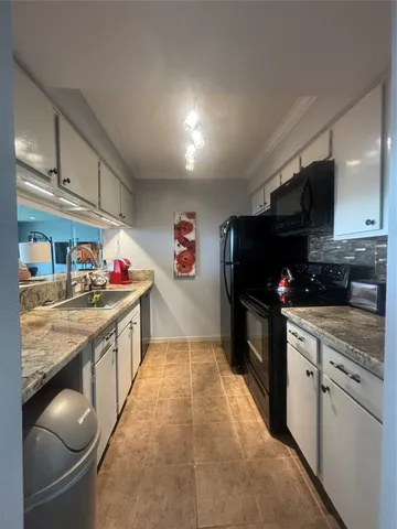 a kitchen with granite countertop lots of counter top space and cabinets