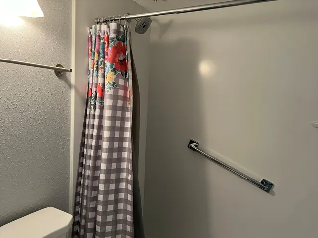 a bathroom with a shower and a toilet