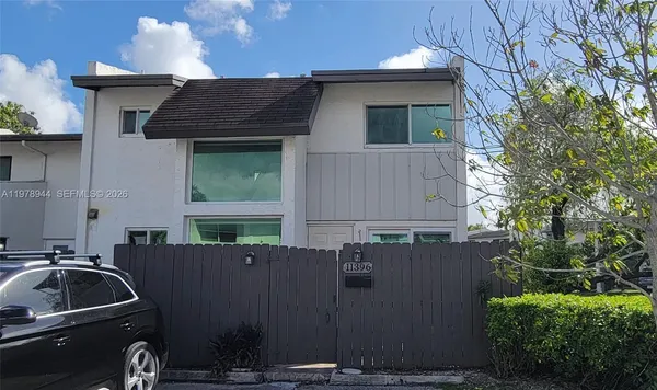 a view of backyard with barbeque grill and plants