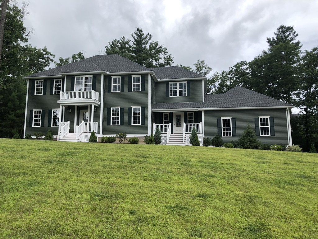 108 Robin Hill Road Groton, MA 01450 - Photo 1 of 24 a front view of a house with a garden