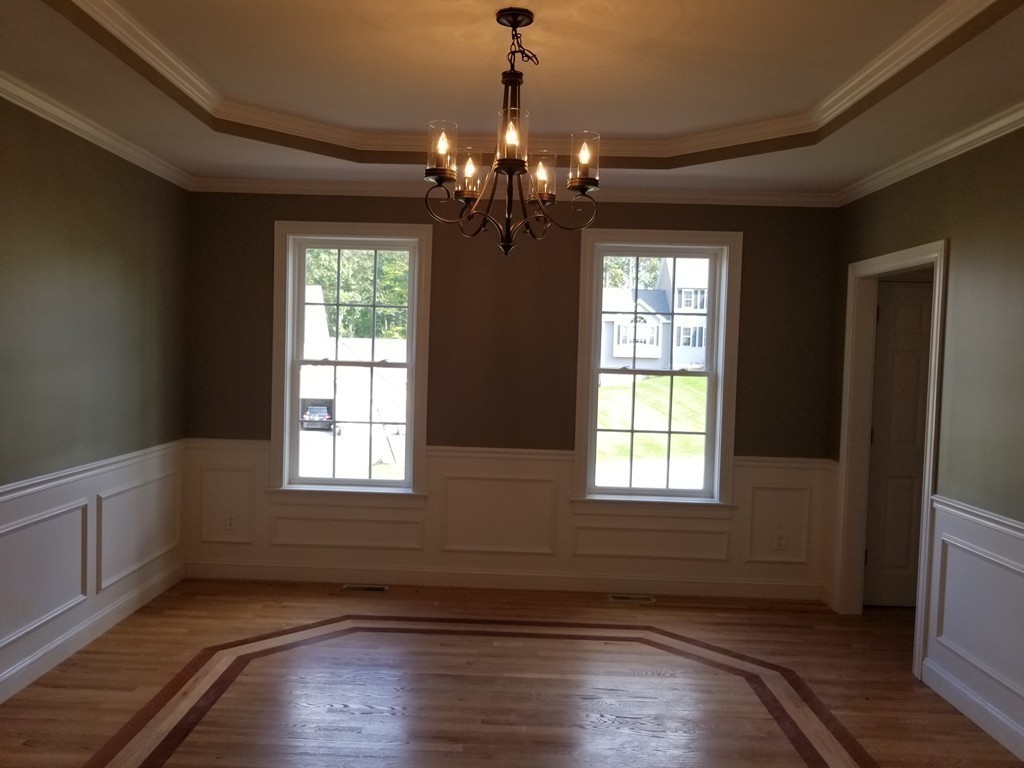108 Robin Hill Road Groton, MA 01450 - Photo 7 of 24 a view of an empty room with wooden floor and a window