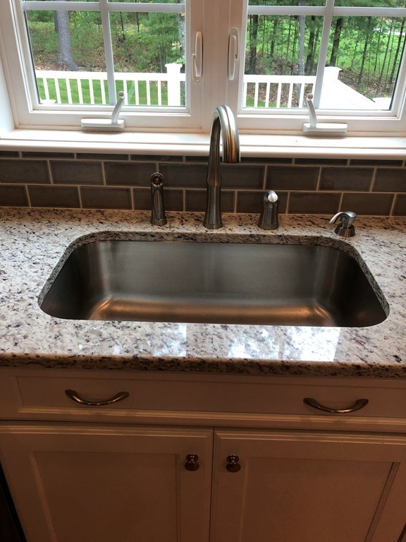108 Robin Hill Road Groton, MA 01450 - Photo 8 of 24 a sink with granite countertop a sink and window