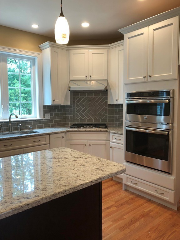 108 Robin Hill Road Groton, MA 01450 - Photo 10 of 24 a kitchen with stainless steel appliances granite countertop a stove a sink and a microwave