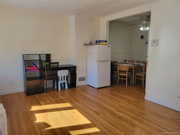 a view of a room with furniture and wooden floor