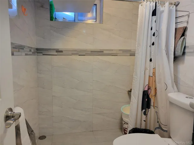 a white toilet sitting next to a bathroom sink