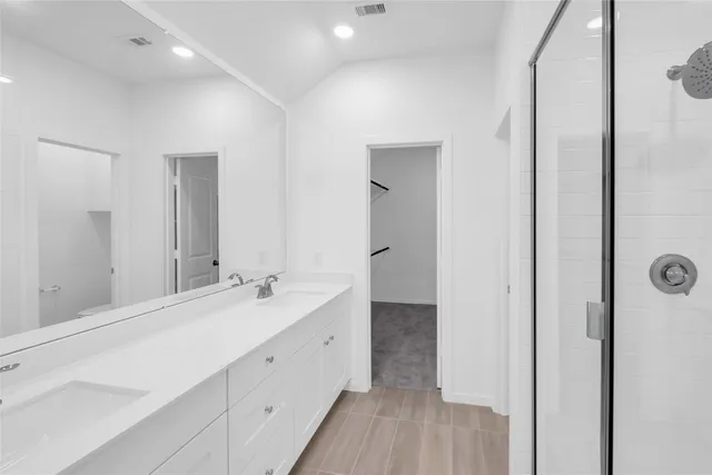 a bathroom with a double vanity sink and a mirror
