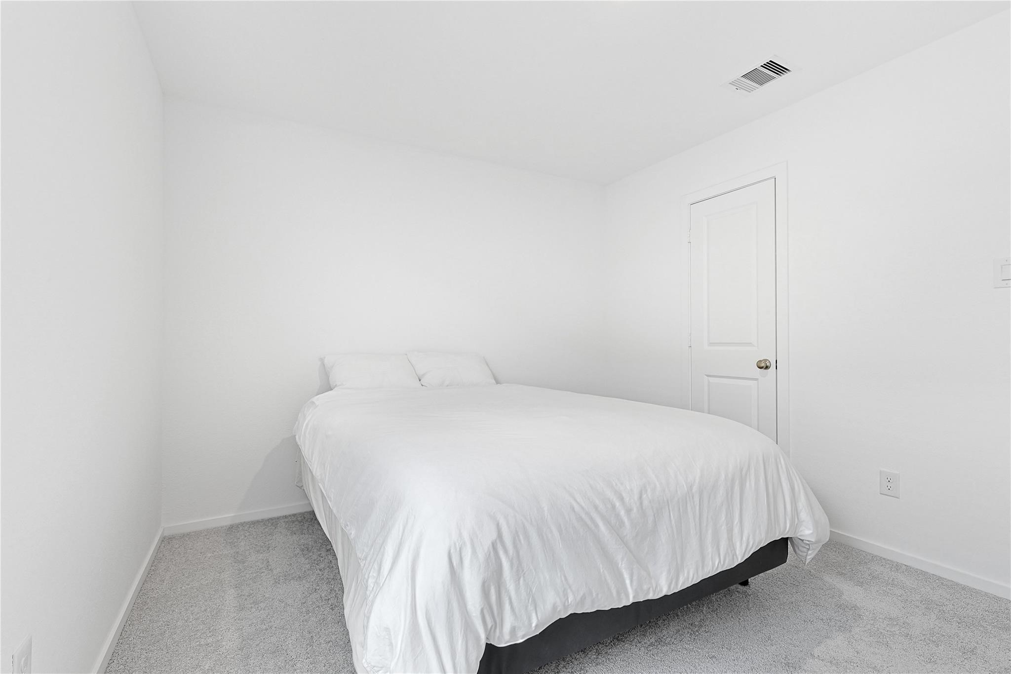 1135 Rustic Willow Drive Beasley, TX 77417 - Photo 14 of 20 a bedroom with a bed and a night stand