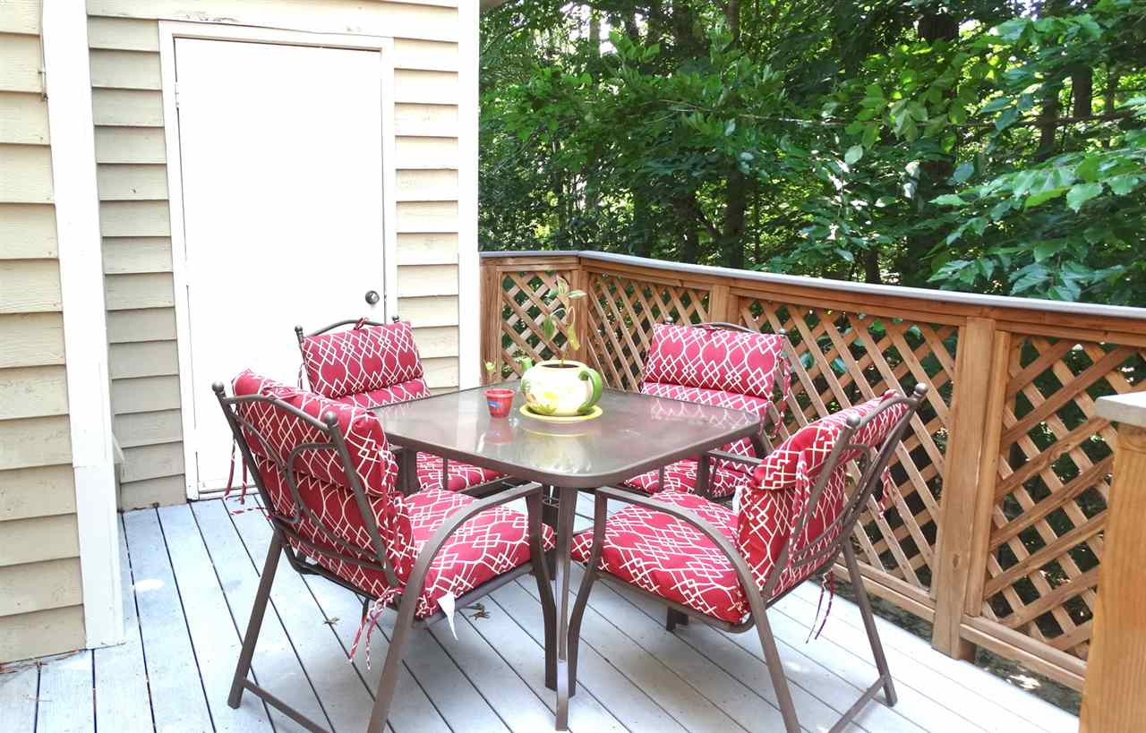 110 Shady Spring Place Durham, NC 27713 - Photo 3 of 22 A 2-level Trex deck with lush greenery behind for outdoor dining and entertainment Patio/Deck