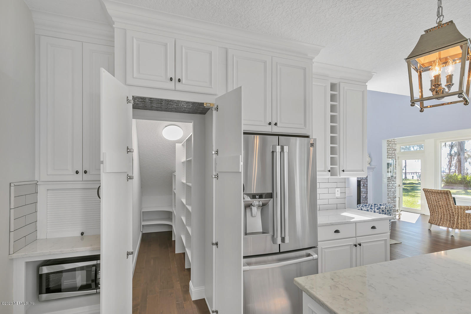 100 River's Edge Road North St. Augustine, FL 32092 - Photo 30 of 67 a kitchen with white cabinets and refrigerator