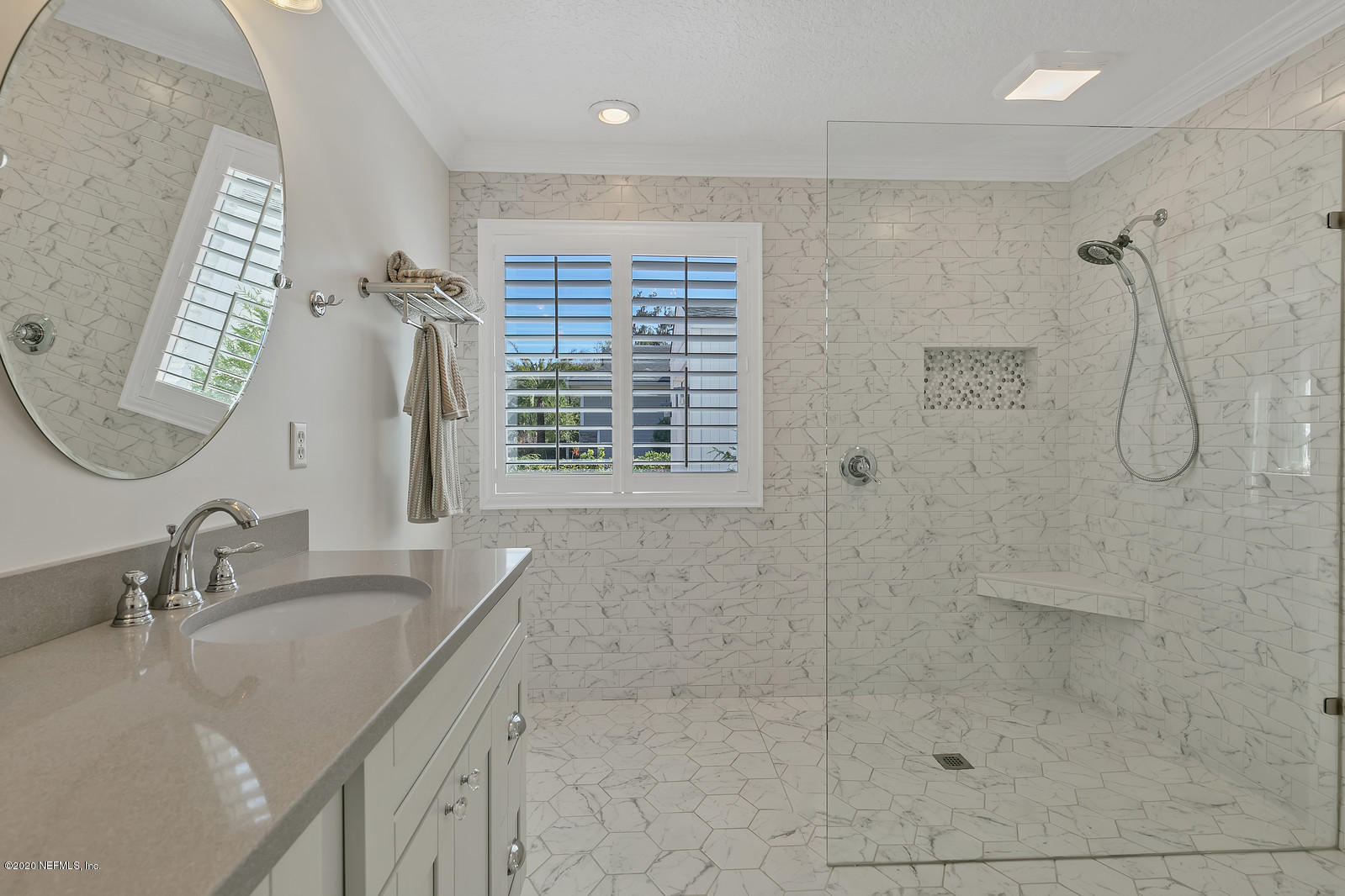 100 River's Edge Road North St. Augustine, FL 32092 - Photo 43 of 67 a bathroom with a shower sink and mirror