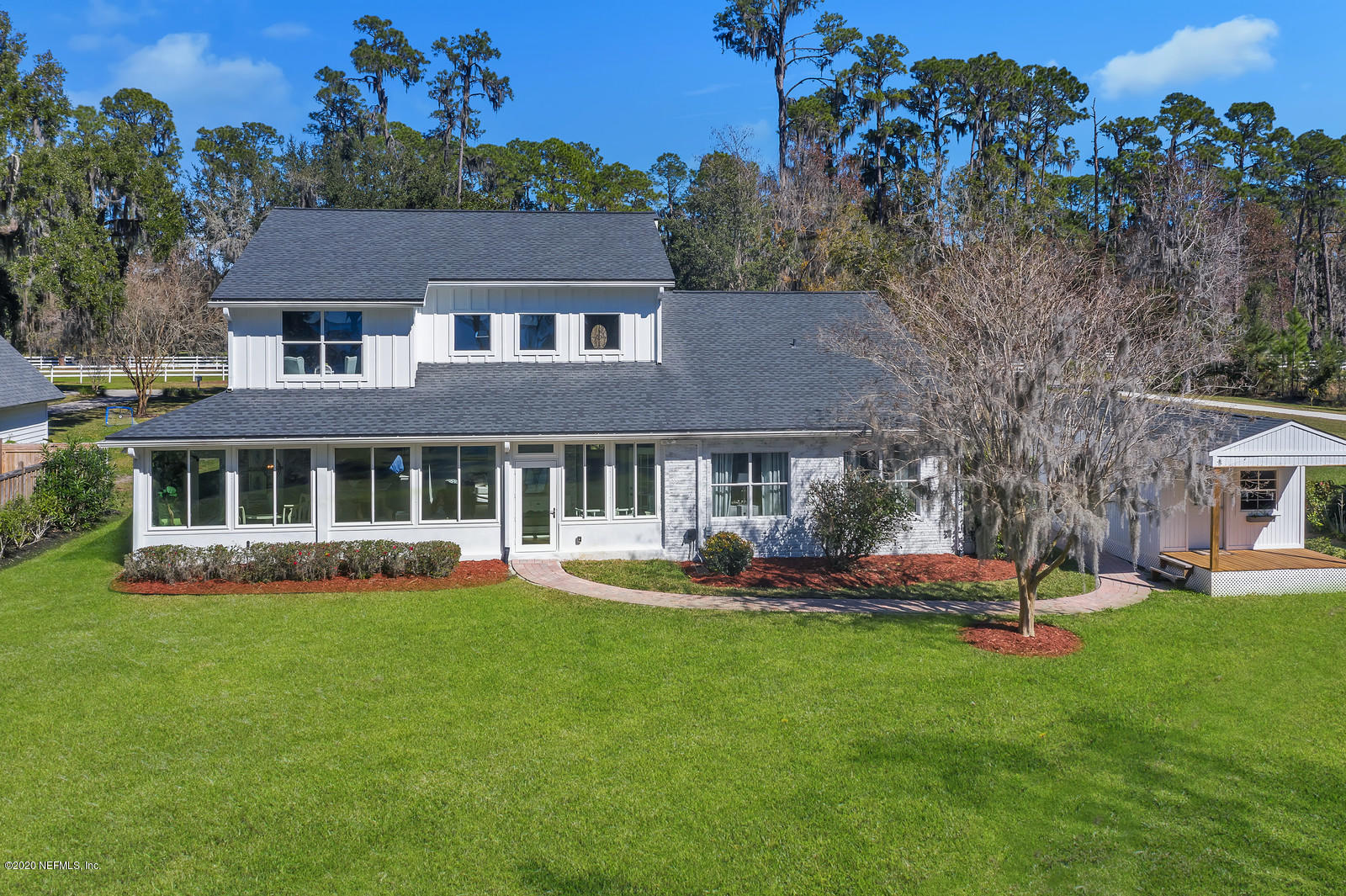 100 River's Edge Road North St. Augustine, FL 32092 - Photo 50 of 67 a front view of a house with a yard table and chairs