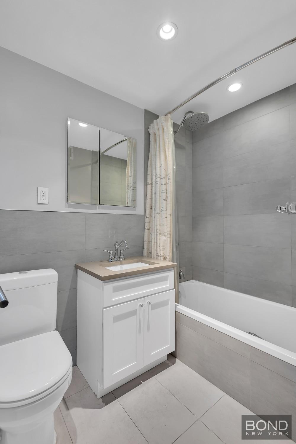 372 Central Park West, Unit 9K Manhattan, NY 10025 - Photo 4 of 8 a bathroom with a sink a toilet and a bathtub