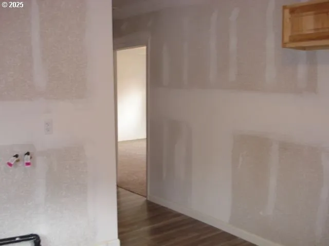 a view of utility room with wooden floor