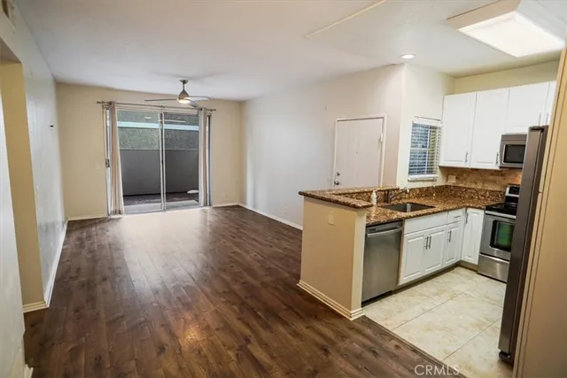 a kitchen with stainless steel appliances granite countertop a stove and a sink