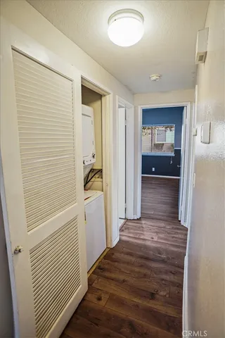 a view of a hallway with wooden floor and closet