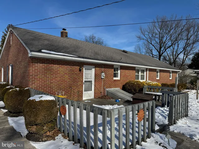 a front view of house with outdoor seating