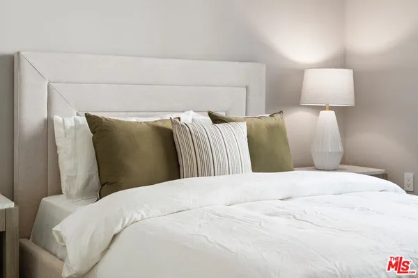 a bedroom with a bed and a lamp