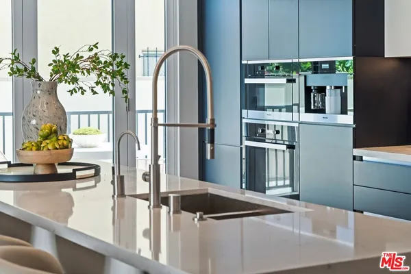 a kitchen with stainless steel appliances granite countertop a refrigerator and a counter