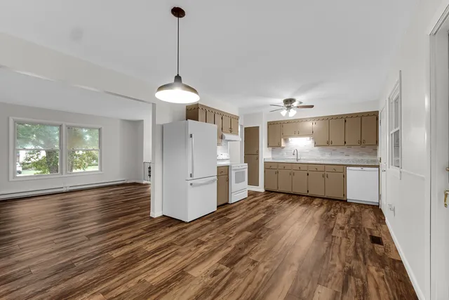 a view of a kitchen with a sink a refrigerator and window