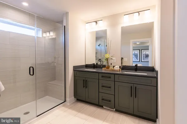 a bathroom with a double vanity sink and mirror