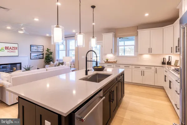 a kitchen with stainless steel appliances granite countertop a sink a stove and a refrigerator