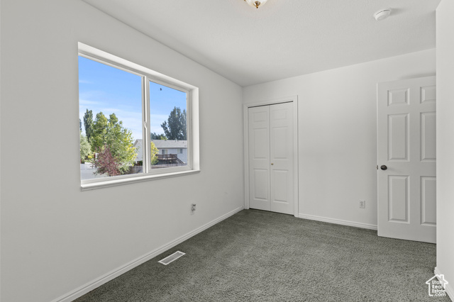1099 Three Point Avenue Logan, UT 84321 - Photo 14 of 27 Unfurnished bedroom featuring carpet flooring and a closet