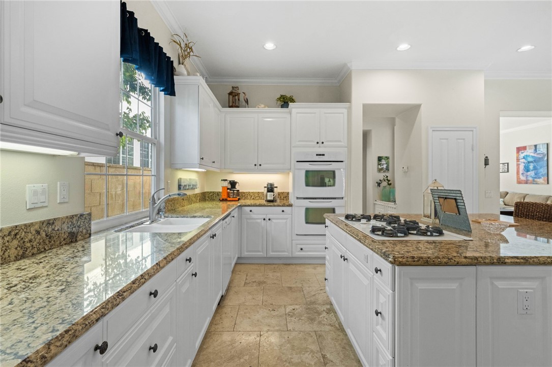23 Winslow Street Ladera Ranch, CA 92694 - Photo 12 of 47 a large kitchen with stainless steel appliances granite countertop a sink stove and refrigerator