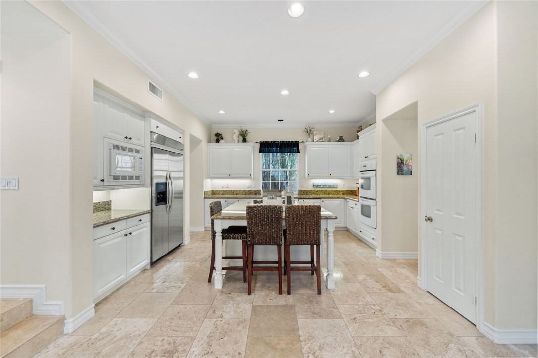 23 Winslow Street Ladera Ranch, CA 92694 - Photo 13 of 47 a kitchen with appliances and cabinets