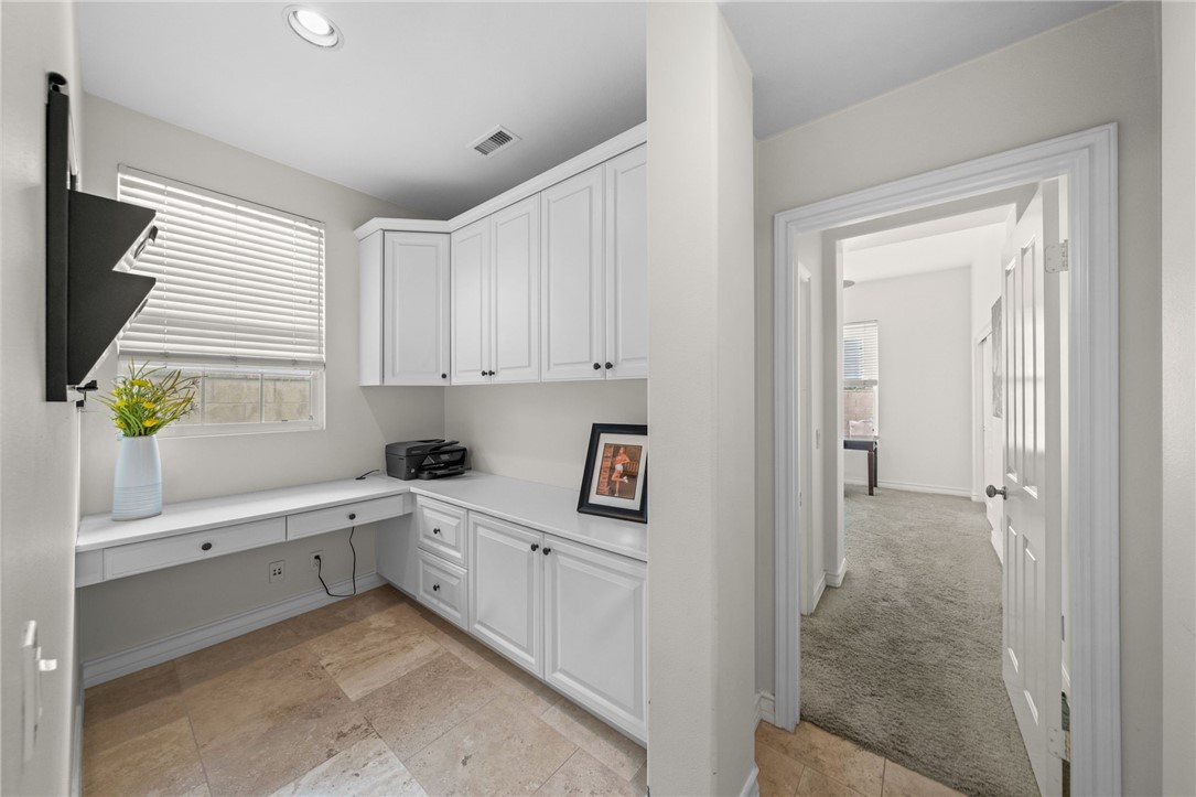 23 Winslow Street Ladera Ranch, CA 92694 - Photo 16 of 47 a kitchen with white cabinets and window