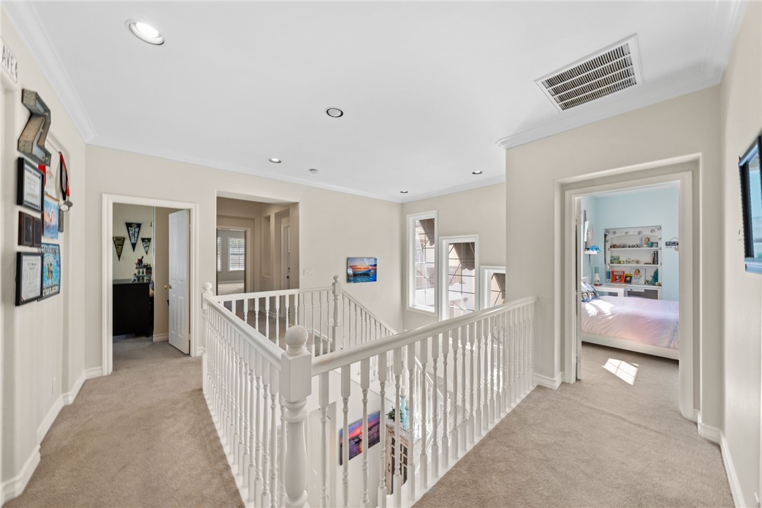 23 Winslow Street Ladera Ranch, CA 92694 - Photo 23 of 47 a view of a hallway to a livingroom with wooden floor and furniture
