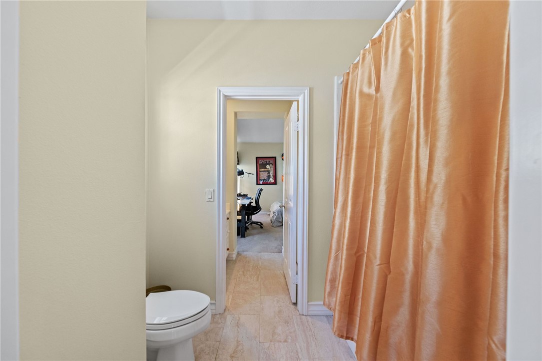 23 Winslow Street Ladera Ranch, CA 92694 - Photo 30 of 47 a bathroom with a toilet and a shower curtain