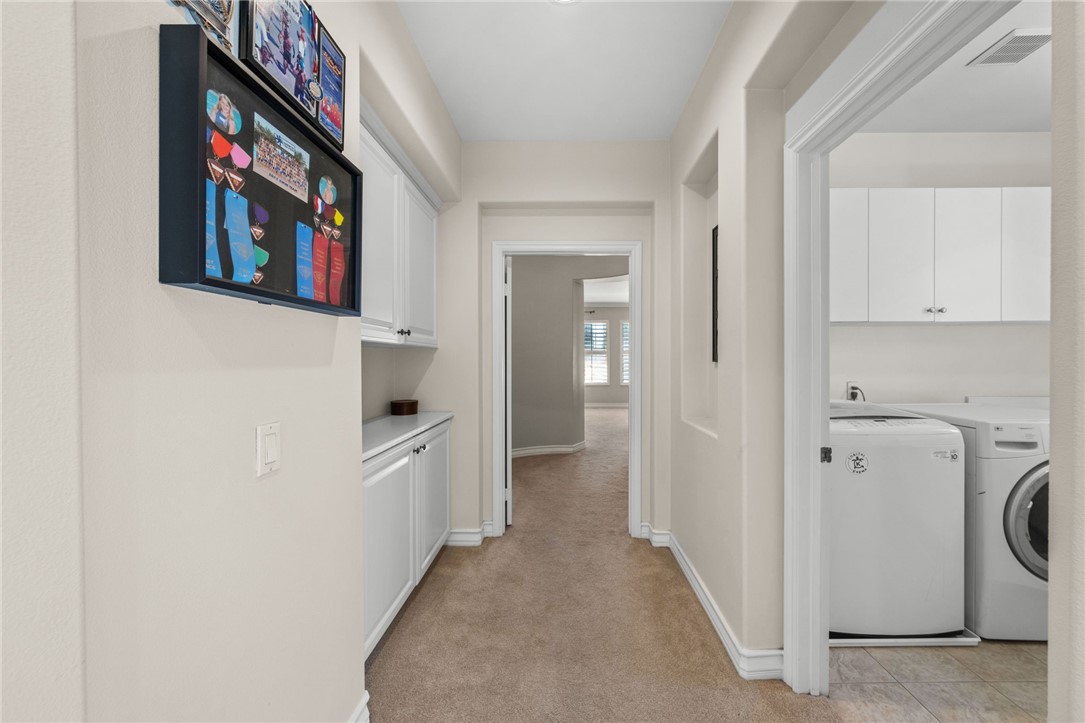 23 Winslow Street Ladera Ranch, CA 92694 - Photo 34 of 47 a hallway with washer and dryer