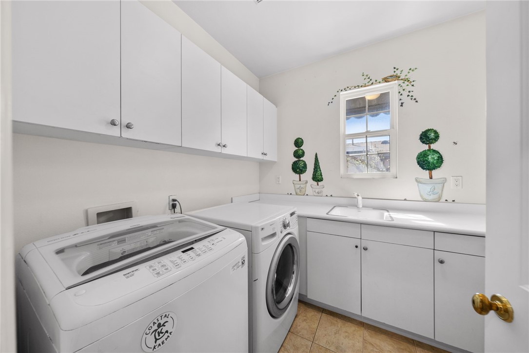 23 Winslow Street Ladera Ranch, CA 92694 - Photo 35 of 47 a utility room with closet dryer and washer