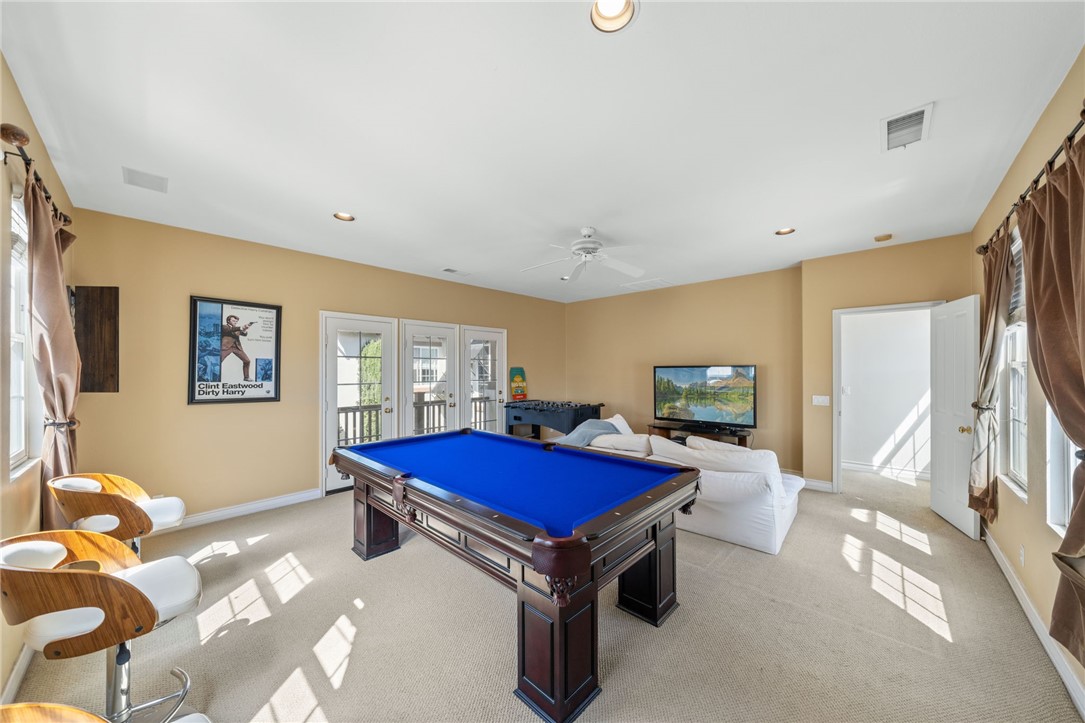 23 Winslow Street Ladera Ranch, CA 92694 - Photo 41 of 47 a living room with furniture gym equipment and a flat screen tv