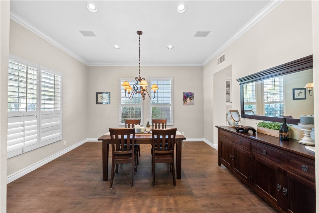 23 Winslow Street Ladera Ranch, CA 92694 - Photo 9 of 47 a dining room with furniture a chandelier and wooden floor
