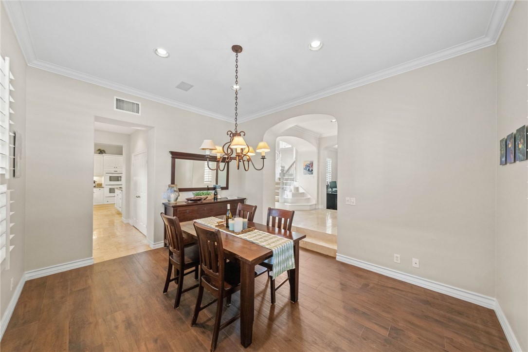 23 Winslow Street Ladera Ranch, CA 92694 - Photo 10 of 47 a view of a dining room with furniture a chandelier and wooden floor