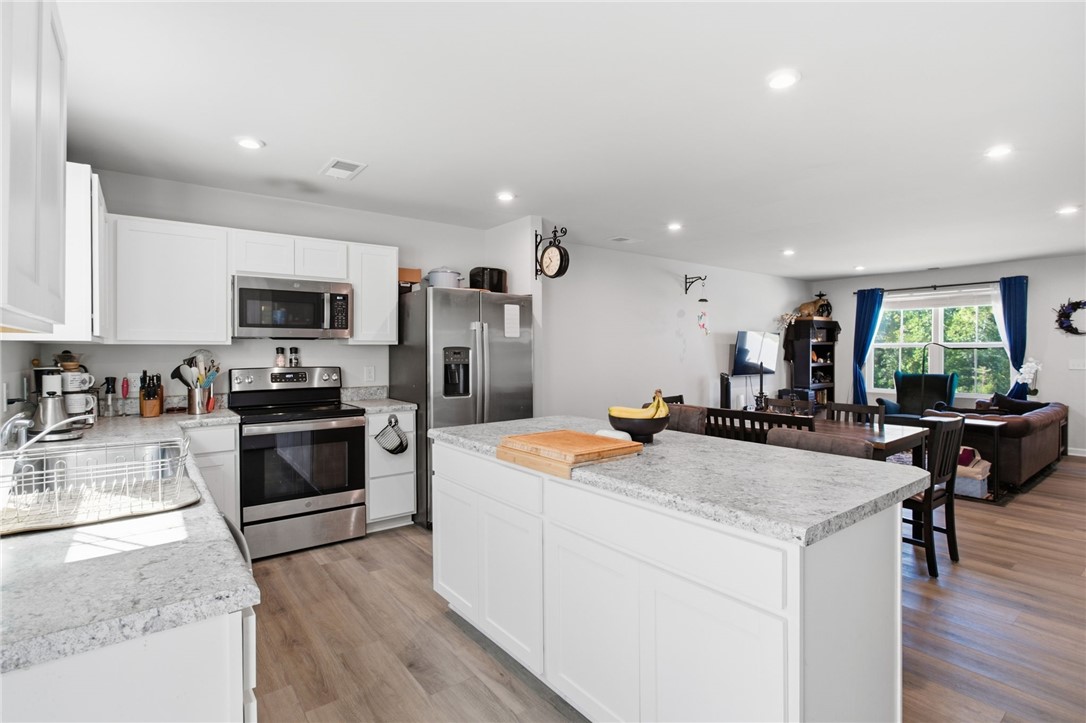 112 Wls Sta Road Seneca, SC 29678 - Photo 13 of 42 Gleaming countertops and a spacious central island anchor this modern open kitchen design.