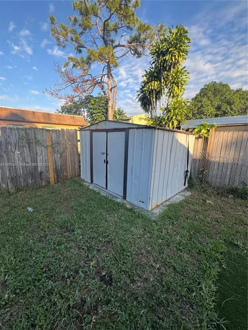 a view of a backyard with wooden fence