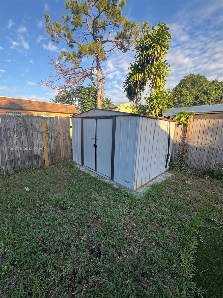 20769 Northwest 41st Avenue Miami Gardens, FL 33055 - Photo 1 of 19 a view of a backyard with wooden fence
