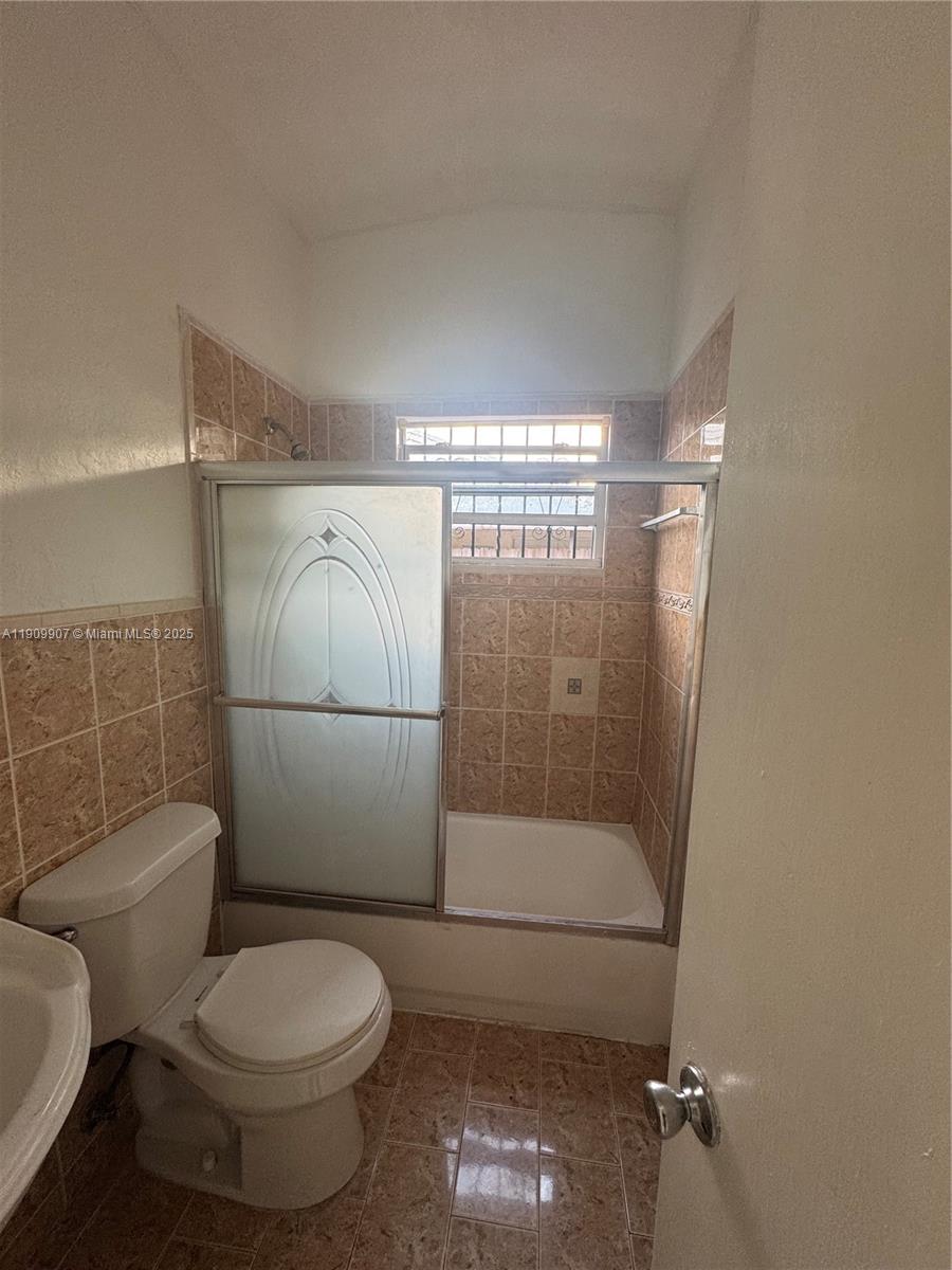 20769 Northwest 41st Avenue Miami Gardens, FL 33055 - Photo 16 of 19 a bathroom with a toilet and a shower
