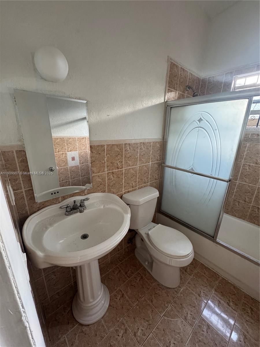 20769 Northwest 41st Avenue Miami Gardens, FL 33055 - Photo 17 of 19 a bathroom with a sink toilet and shower