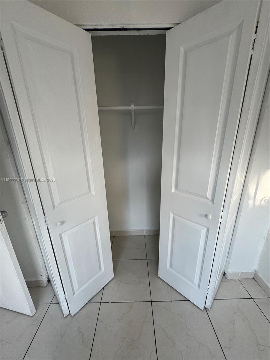 20769 Northwest 41st Avenue Miami Gardens, FL 33055 - Photo 19 of 19 a view of walk in closet with empty racks