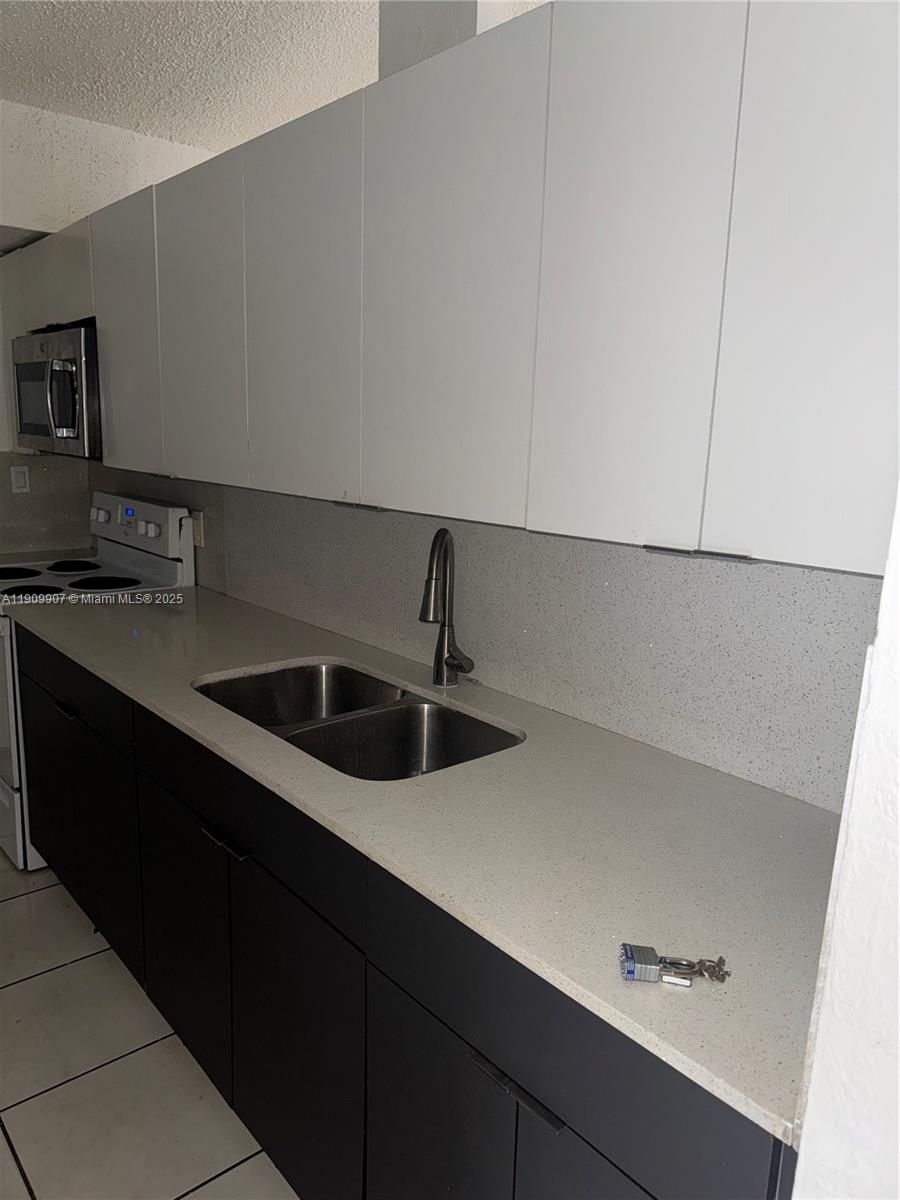 20769 Northwest 41st Avenue Miami Gardens, FL 33055 - Photo 7 of 19 a kitchen with a sink and cabinets
