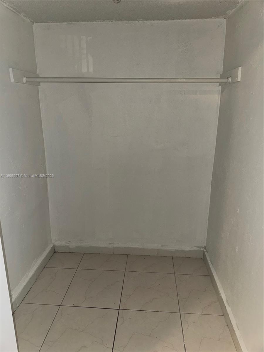 20769 Northwest 41st Avenue Miami Gardens, FL 33055 - Photo 8 of 19 a view of a room with racks on the wall