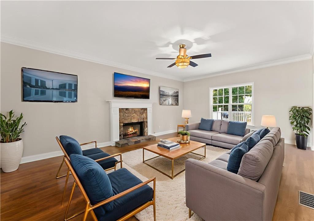 41 Doster Crest Road Jefferson, GA 30549 - Photo 11 of 56 a living room with furniture a fireplace and a flat screen tv