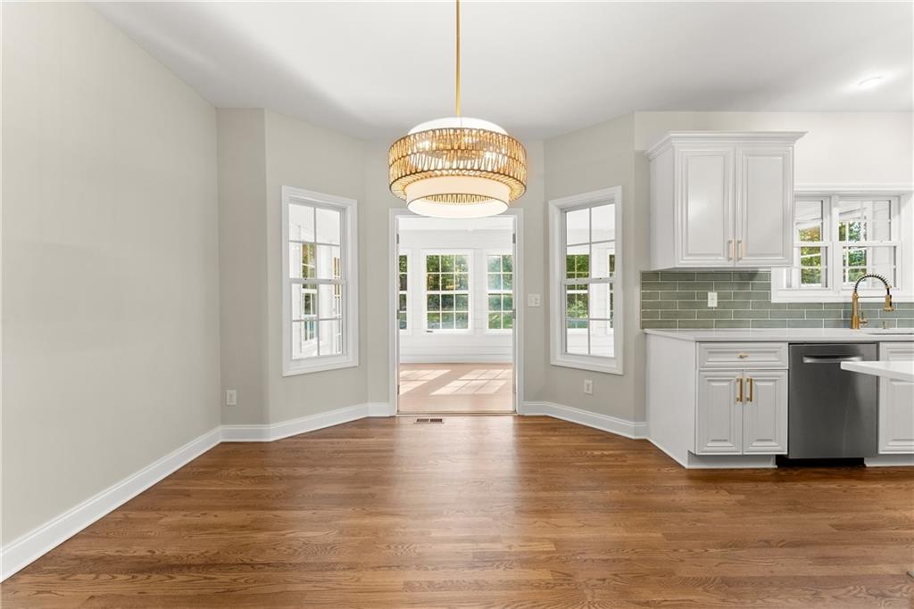 41 Doster Crest Road Jefferson, GA 30549 - Photo 18 of 56 a view of a kitchen with granite countertop a stove a sink a window and wooden floor