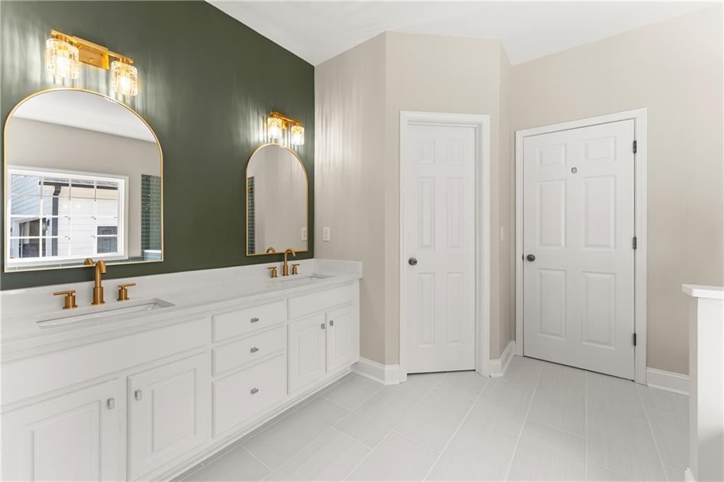 41 Doster Crest Road Jefferson, GA 30549 - Photo 28 of 56 a bathroom with a double vanity sink and a mirror